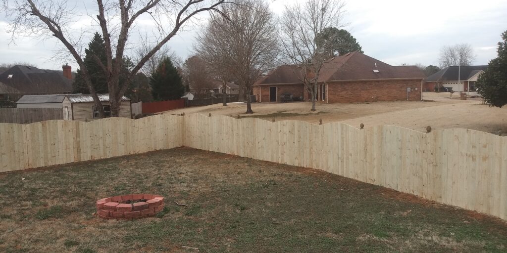 Cedar privacy fence running along a residential property line in Huntsville AL