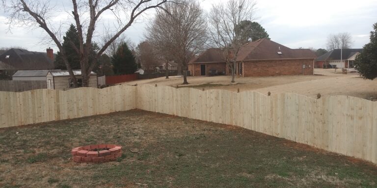 Cedar privacy fence running along a residential property line in Huntsville AL